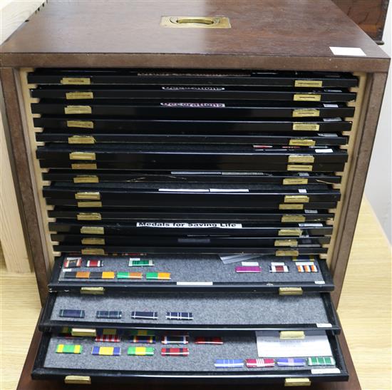 A collectors cabinet of British and Foreign medal ribbons